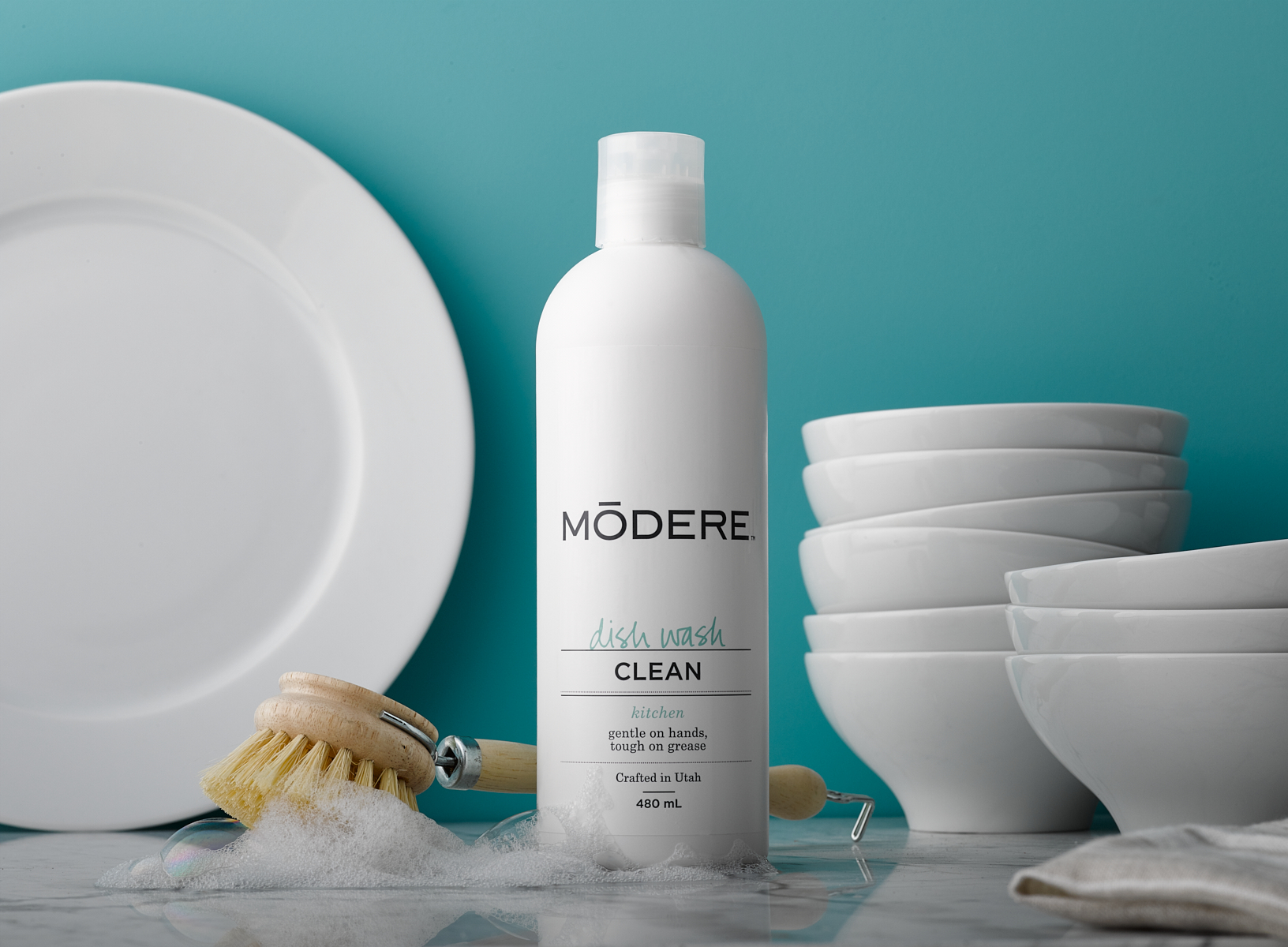 Modere dishwashing  products with dishes and bowls stacked up 
