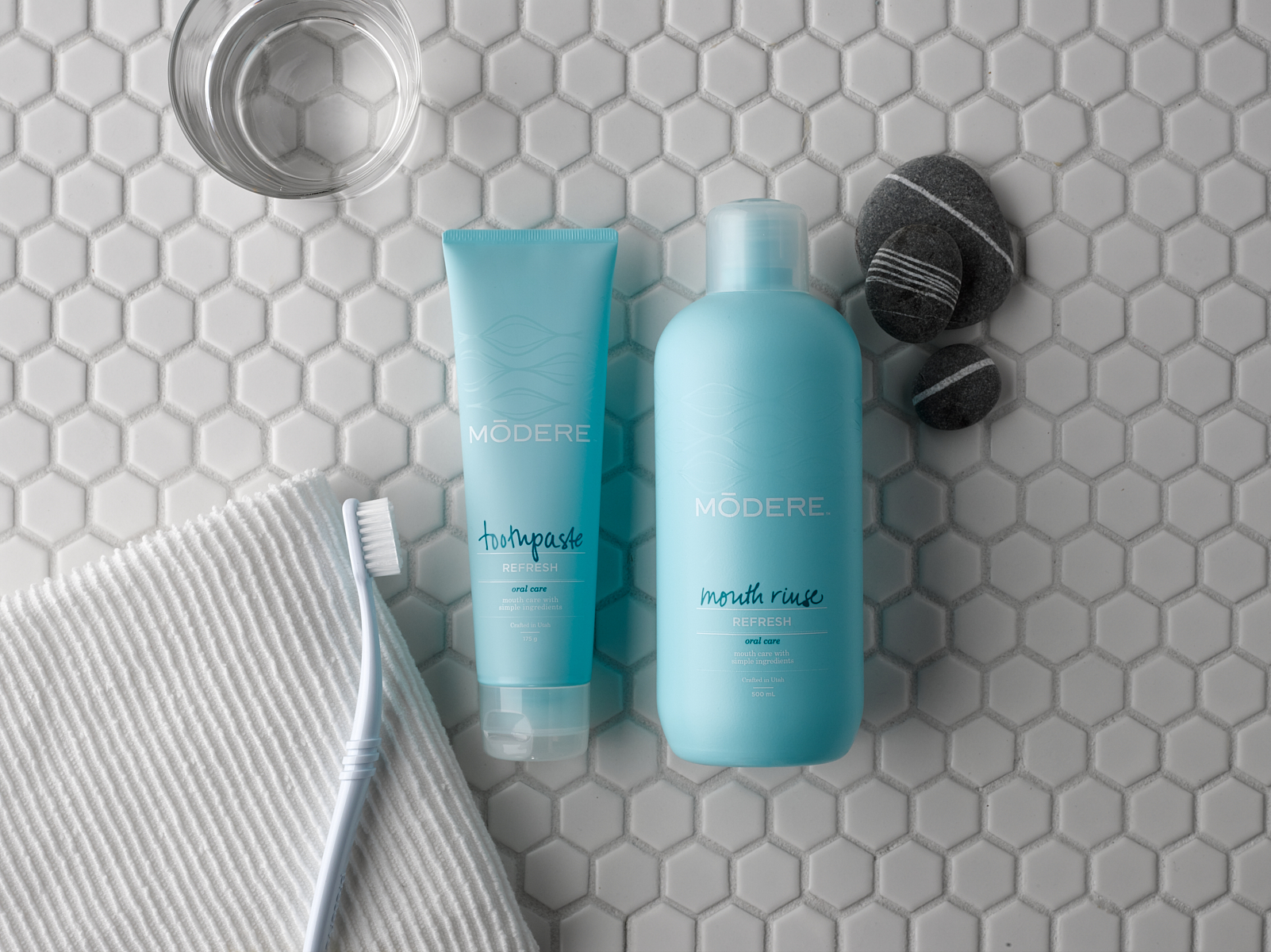 Modere mouth care products with bathroom items on counter 